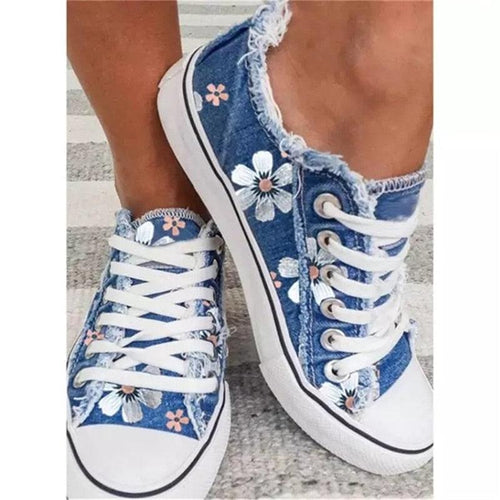 Close-up of lace-up closure on floral canvas sneaker