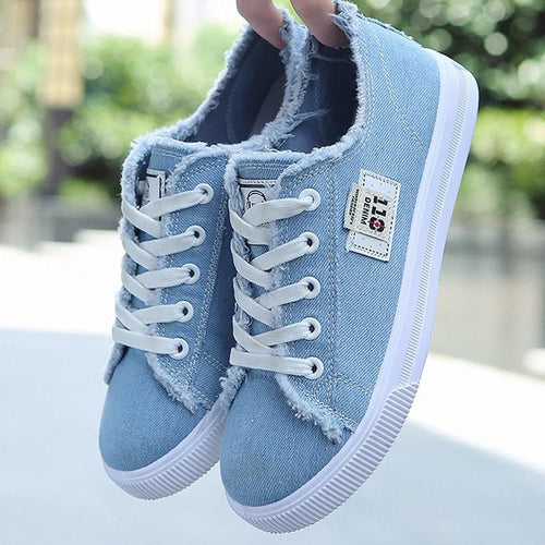 Close-up of lace-up closure on classic canvas sneaker
